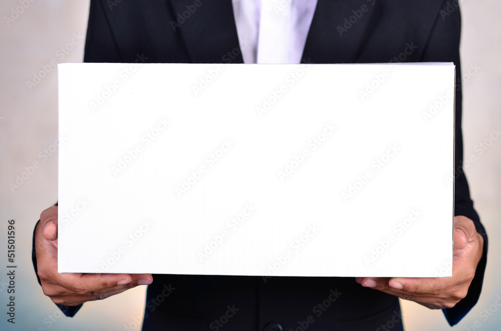 Business man holding white box