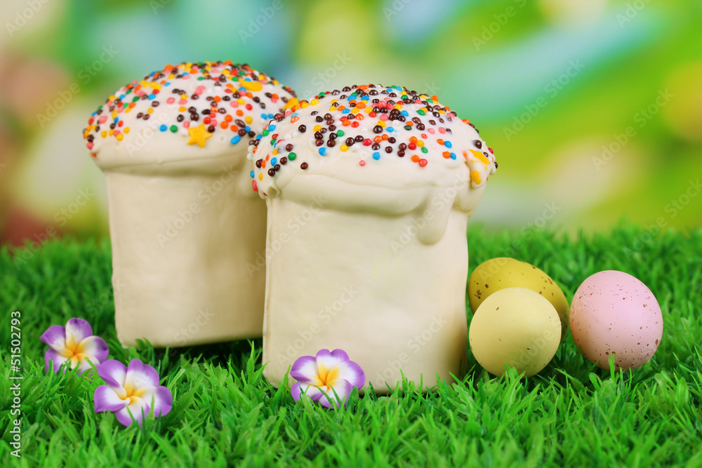 Fototapeta premium Easter cake with sugar glaze and eggs on grass