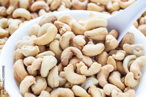 Salted Cashews in White Bowl with Spoon