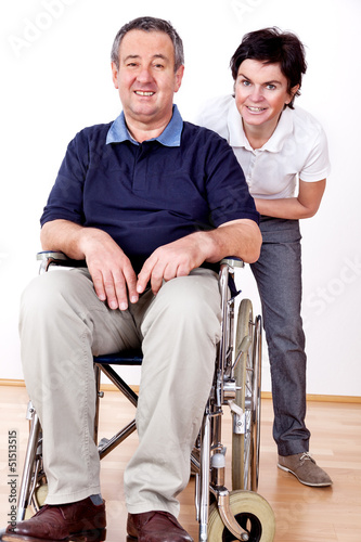 Woman is friendly and shoves man in wheelchair © Edler von Rabenstein