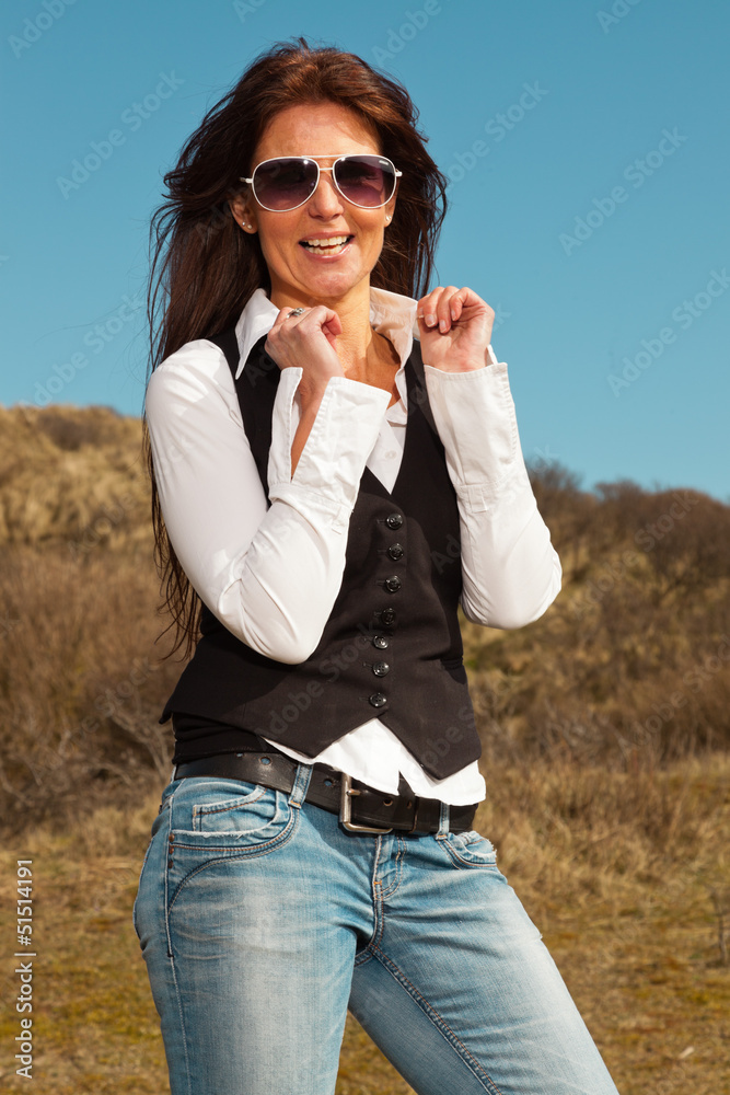 Happy pretty brunette woman wearing jeans and sunglasses outdoor Happy pretty brunette woman wearing jeans and sunglasses outdoor