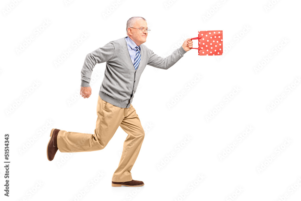 Full length portrait of a mature gentleman running with a gift b Full length portrait of a mature gentleman running with a gift b