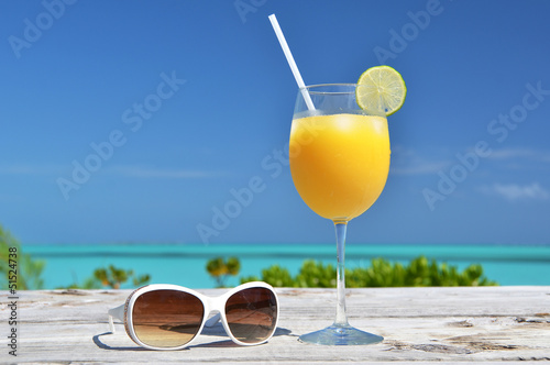 Orange juice and sunglasses. Exuma island, Bahamas