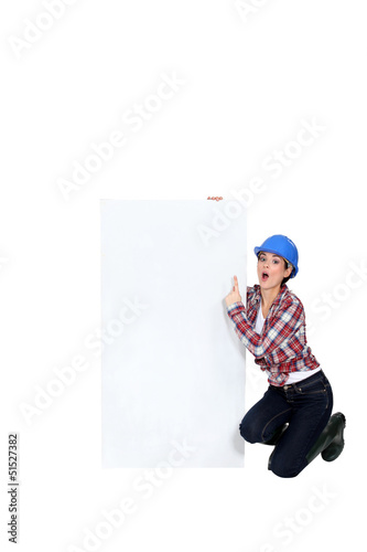 Construction worker pointing at poster. © auremar