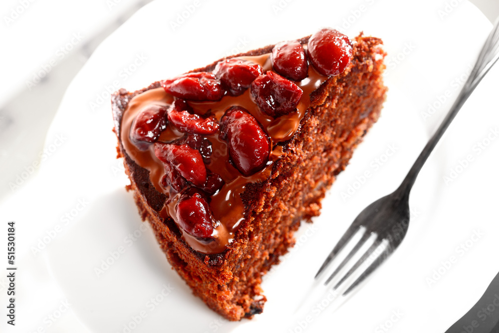 Piece of chocolate cake with icing and cherry Piece of chocolate cake with icing and cherry