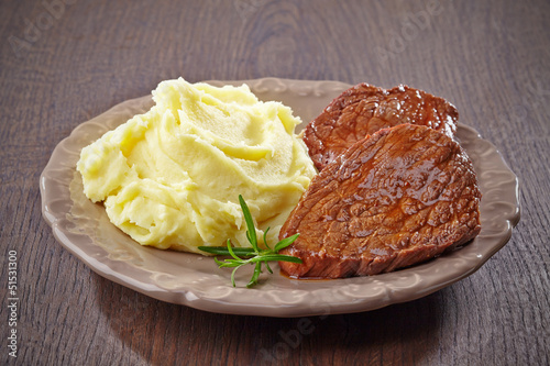 mashed potatoes and beef steak on plate
