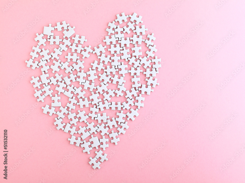 puzzle made heart sharp on pink background