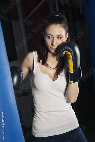 Punching boxing woman portrait in the gym.
