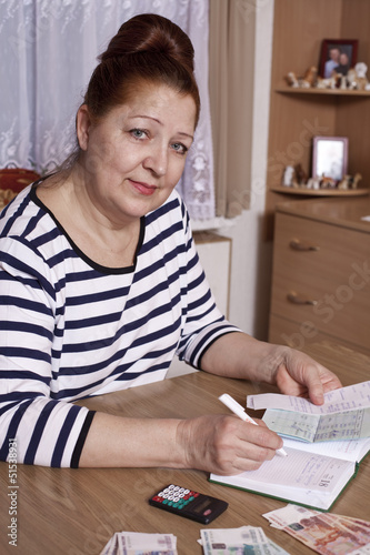Elderly woman holding money in hand