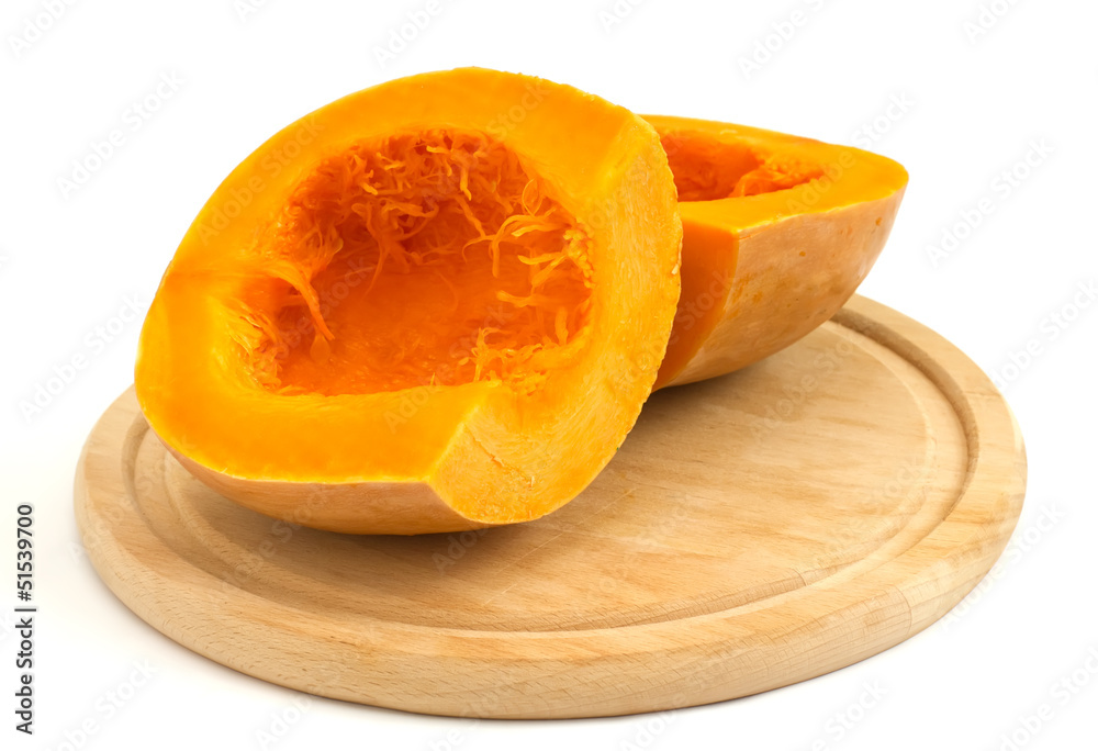 Fresh uncooked pumpkin on board on white Fresh uncooked pumpkin on board on white