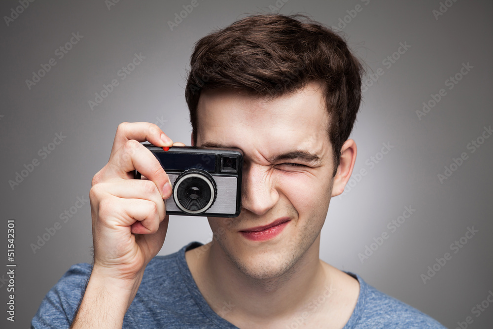 Young man with vintage camera