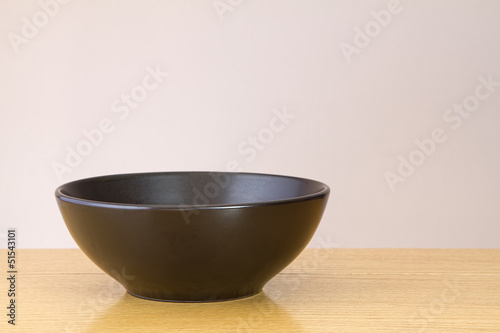 Black bowl on wooden table