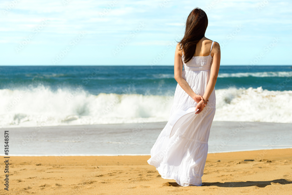 Woman on beach looking the sea