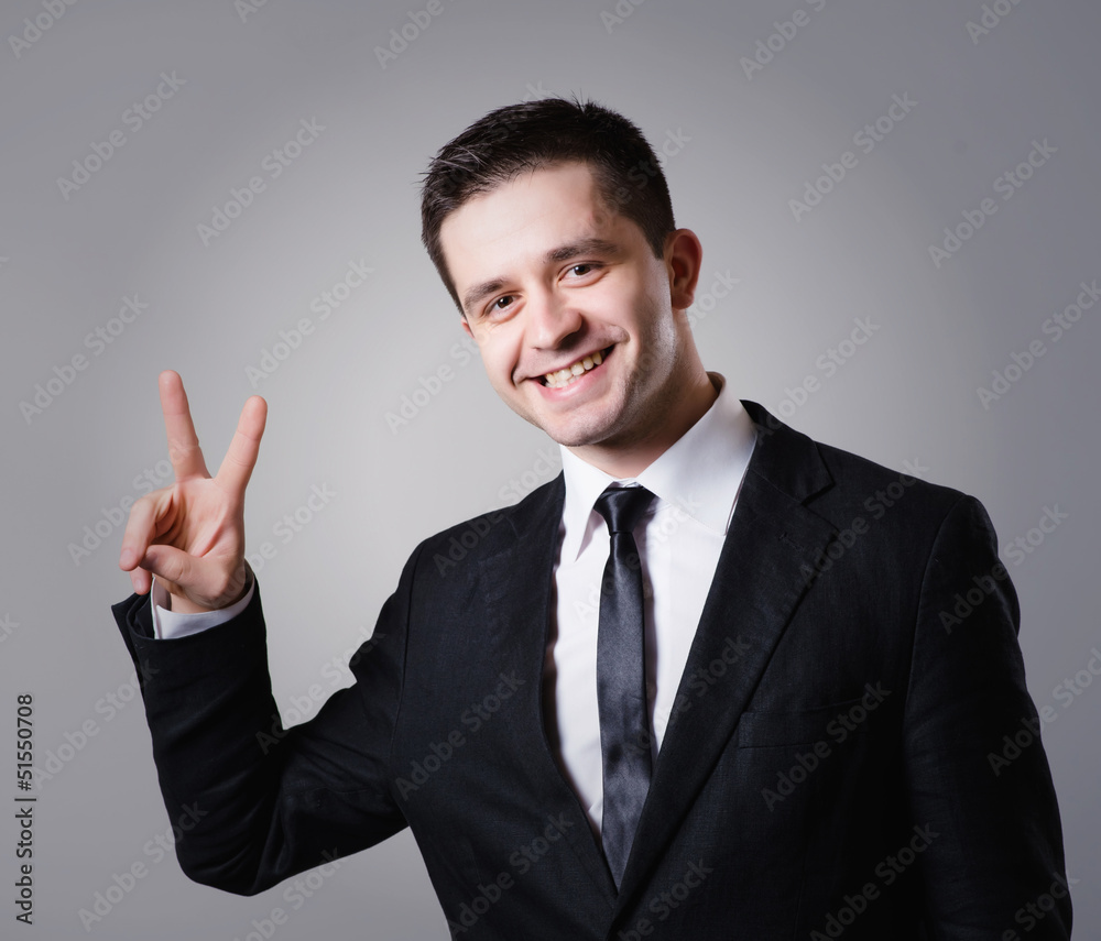 business man showing two fingers or victory gesture business man showing two fingers or victory gesture