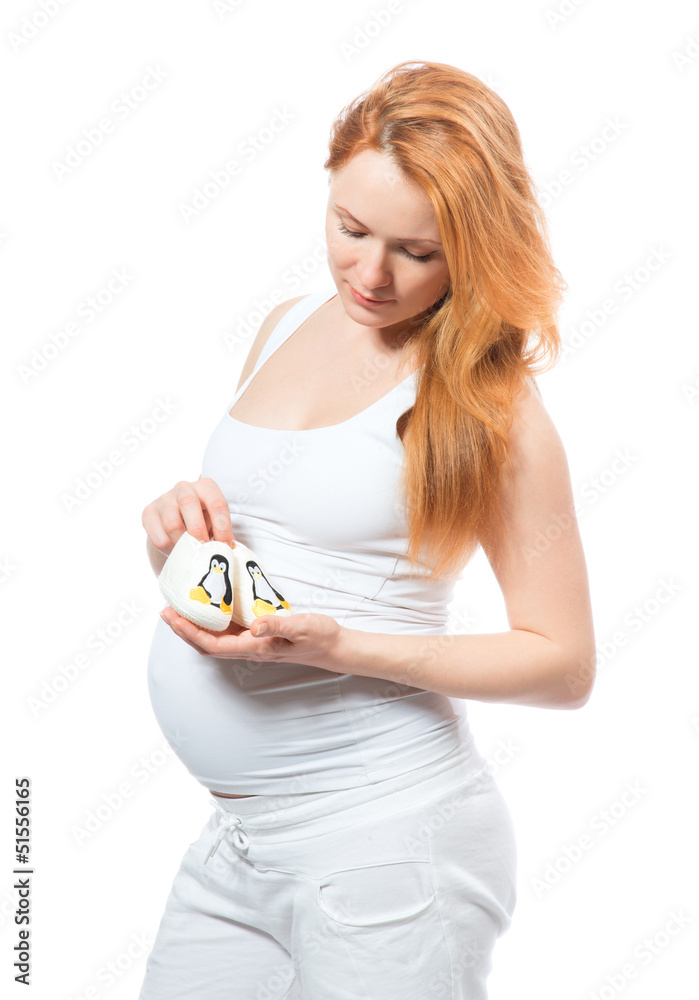Pregnant woman hold small children's slippers Pregnant woman hold small children's slippers