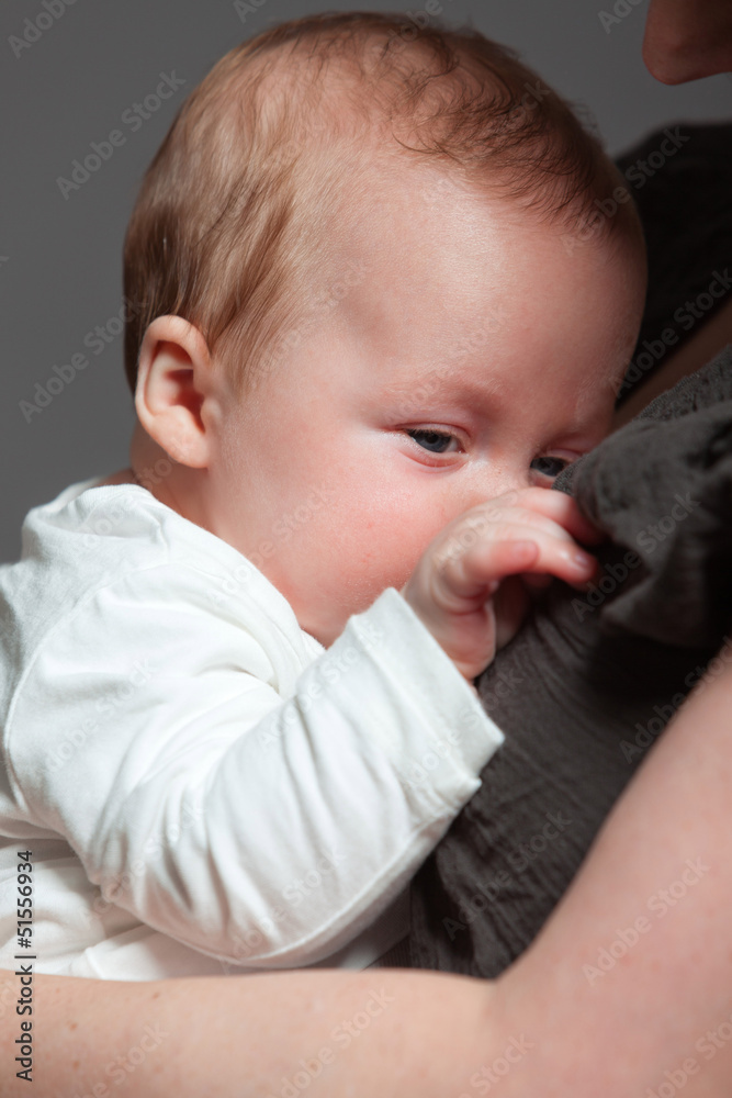 Baby daughter in the arms of mom. Studio shot. Baby daughter in the arms of mom. Studio shot.