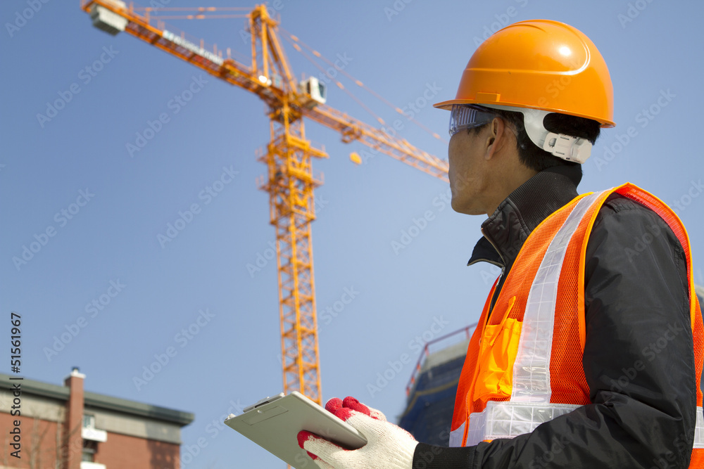 construction worker with crane in background construction worker with crane in background