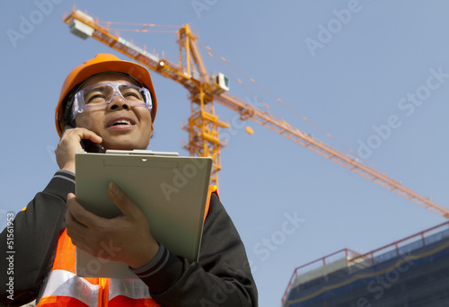 construction worker with crane in background