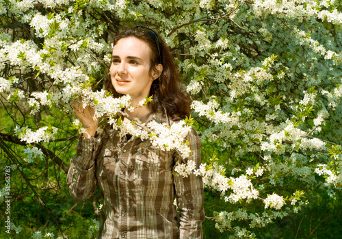 Beautiful young woman enjoys the coming of spring
