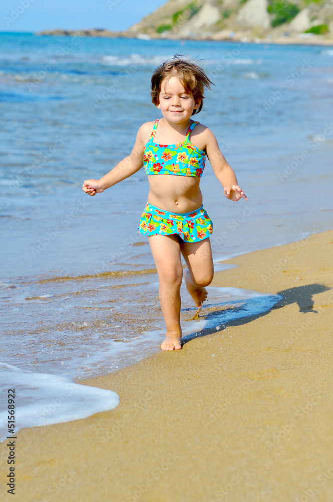 Happy toddler girl running on the beach Happy toddler girl running on the beach