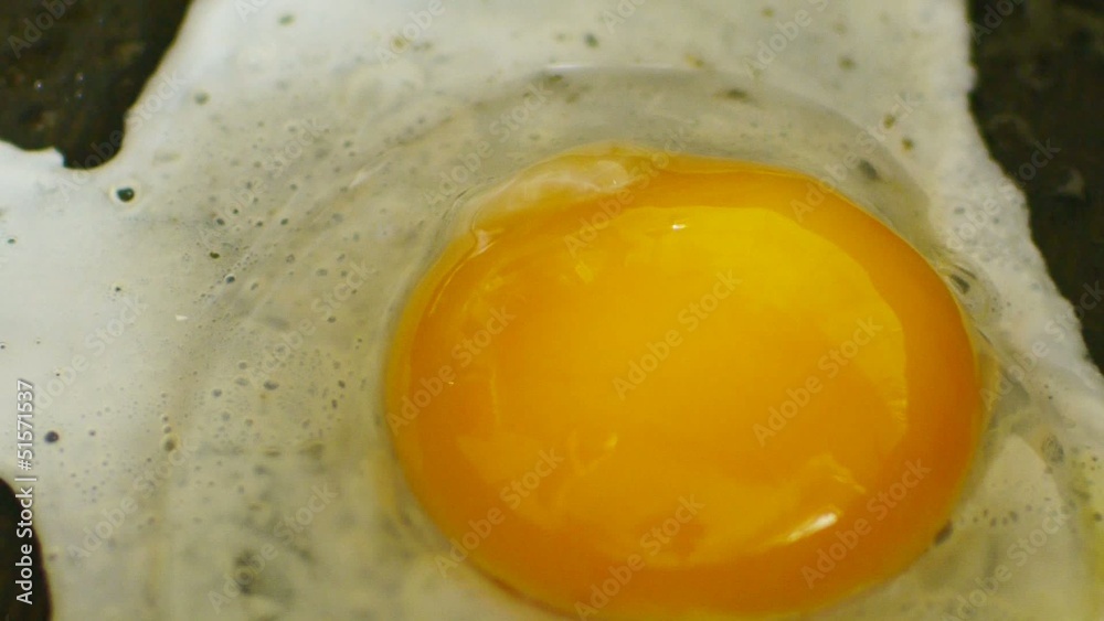 HD1080 Fried egg on black pan with sound HD1080 Fried egg on black pan with sound