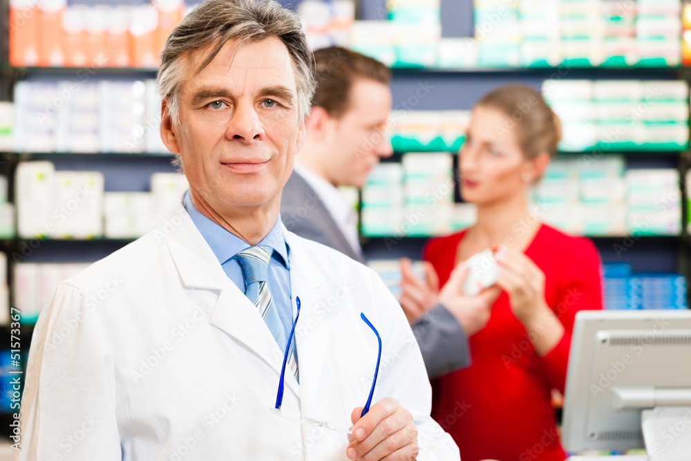 Pharmacist with customers in pharmacy Pharmacist with customers in pharmacy