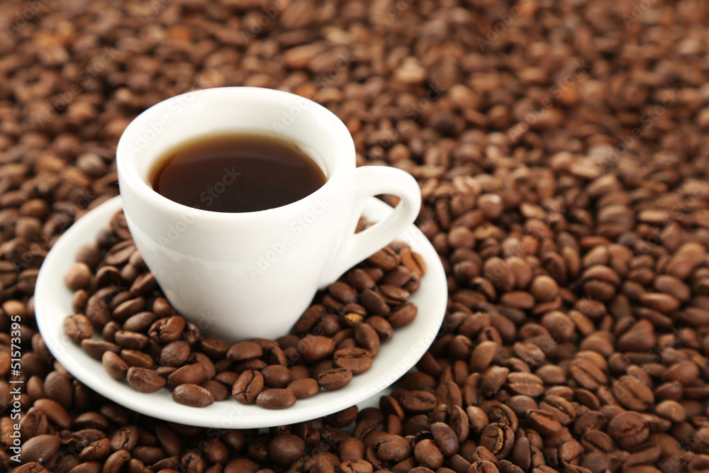 Cup of coffee on coffee beans background Cup of coffee on coffee beans background