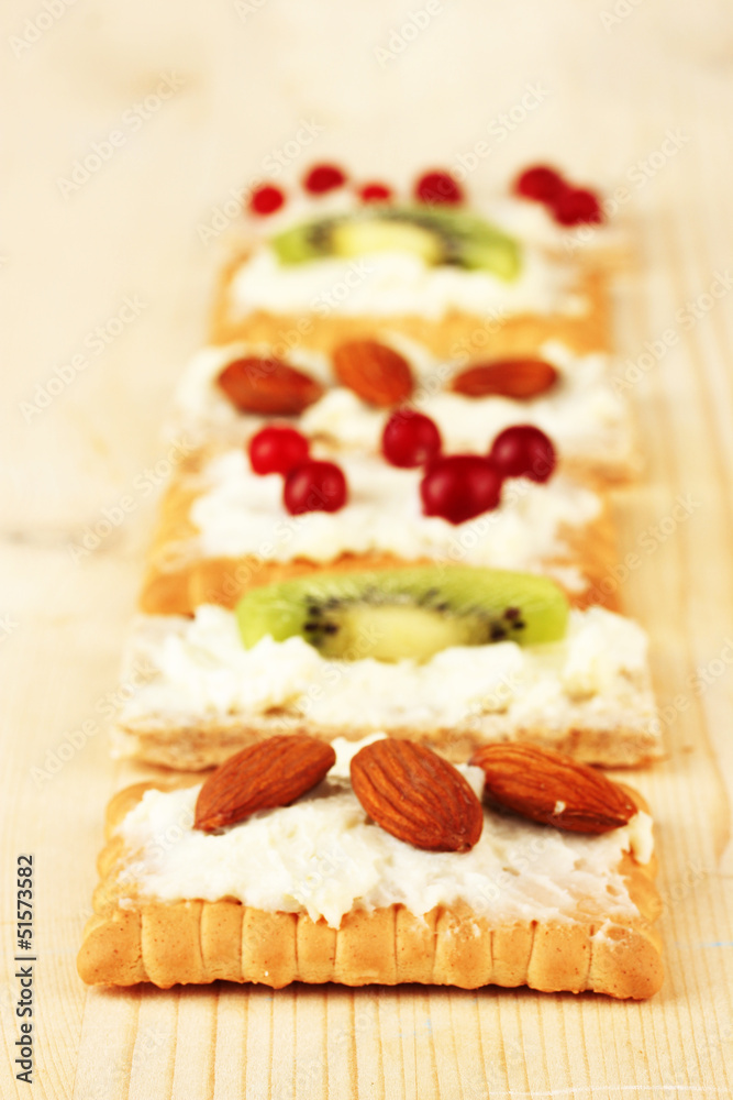 Tasty canapes with cheese, kiwi and cranberry, almond, Tasty canapes with cheese, kiwi and cranberry, almond,