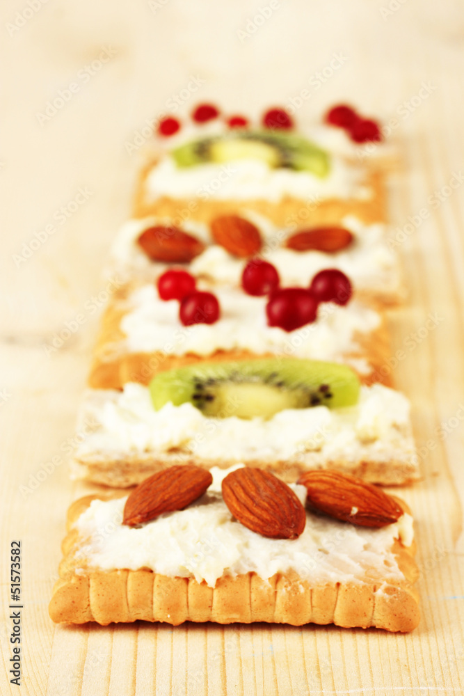 Tasty canapes with cheese, kiwi and cranberry, almond,