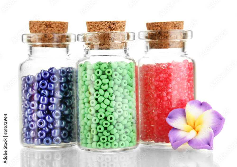 Little bottles full with colorful beads isolated on white Little bottles full with colorful beads isolated on white