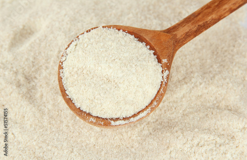 Powdered milk with spoon for baby close-up