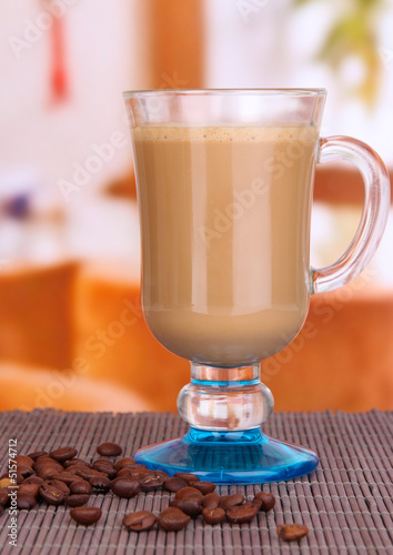 Layered coffee in glass on table on bright background