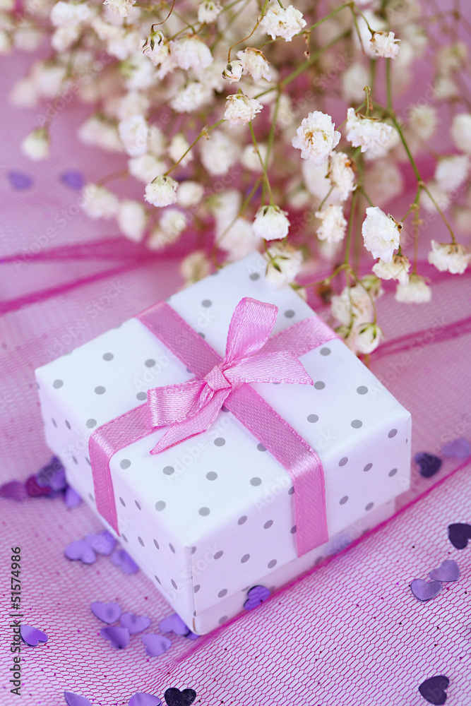 Flowers and gift box on pink background Flowers and gift box on pink background