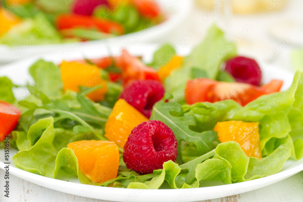 salad with raspberries on plate salad with raspberries on plate