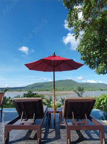 Relaxing beds and red umbrella mountain view