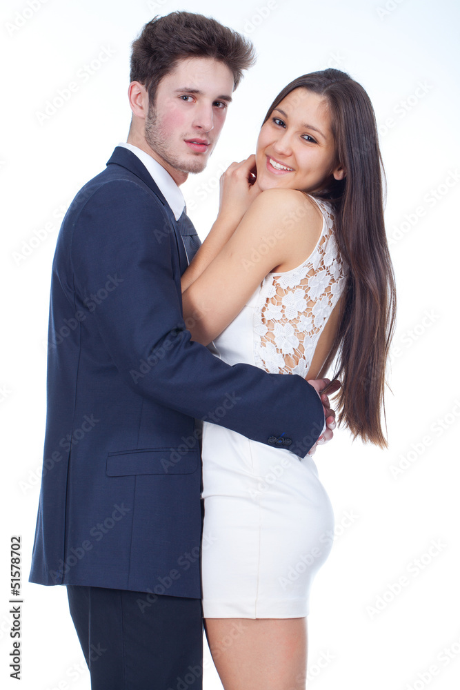 young couple looking happy, with white background behind young couple looking happy, with white background behind