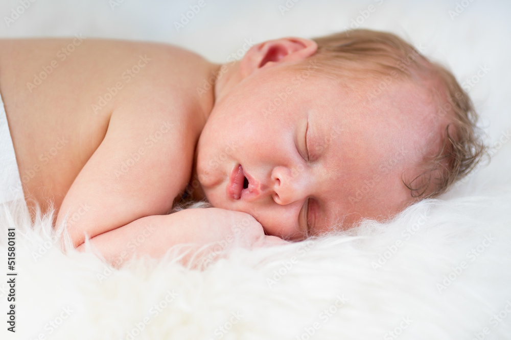 newborn baby boy sleeping on fur bed newborn baby boy sleeping on fur bed
