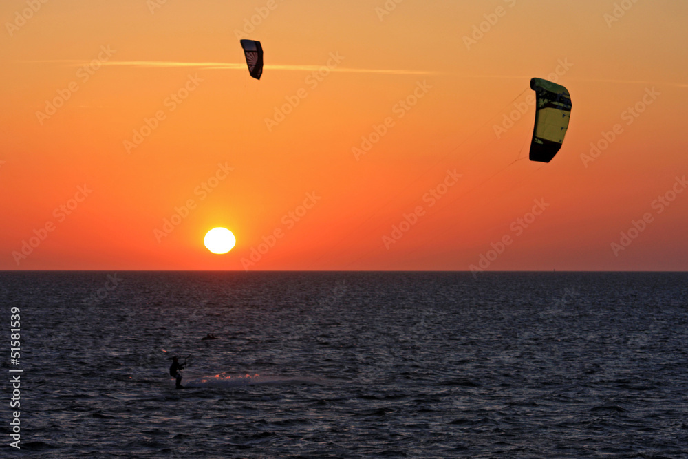 kitesurfers at sunset