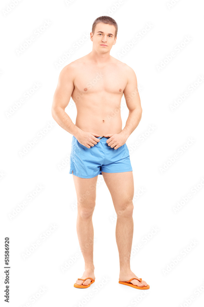 Full length portrait of a handsome muscular man posing in swimsu