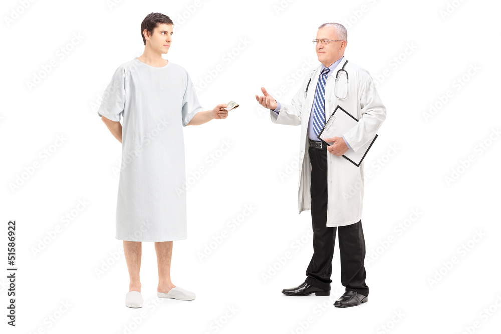 Full length portrait of a male patient offering money to a docto Full length portrait of a male patient offering money to a docto