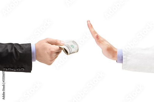 Man giving bribe to a doctor refusing the money