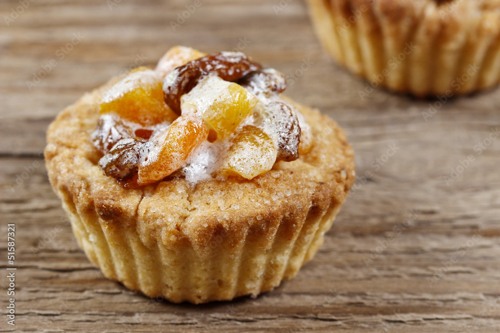 Homemade tart with dried fruits on wooden table