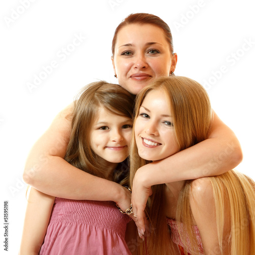 happy mother hugs daughters