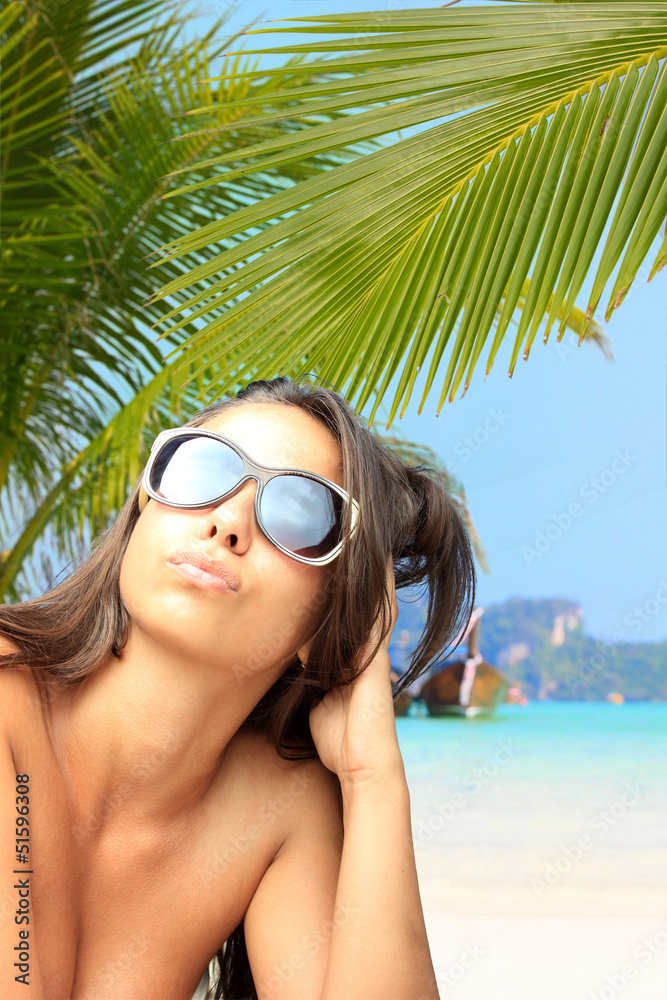 Woman on the beach at tropical resort Woman on the beach at tropical resort