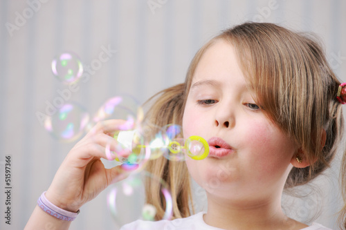 Little girll blowing bubbles