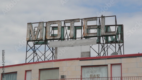 Motel sign. Pigeons landing.