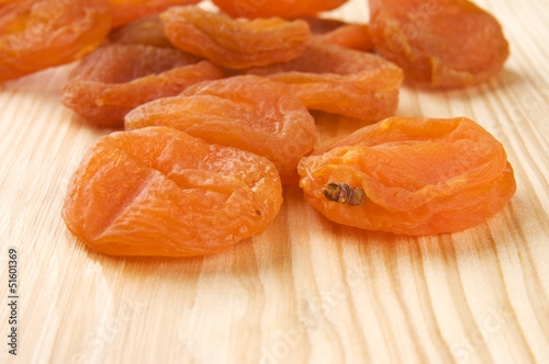 Dried apricots on wooden background close up