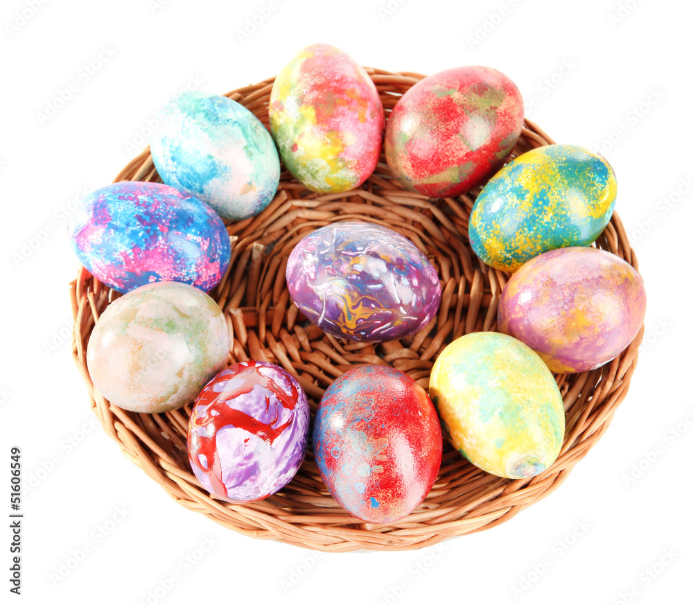 Beautiful Easter eggs in wicker basket isolated on white Beautiful Easter eggs in wicker basket isolated on white