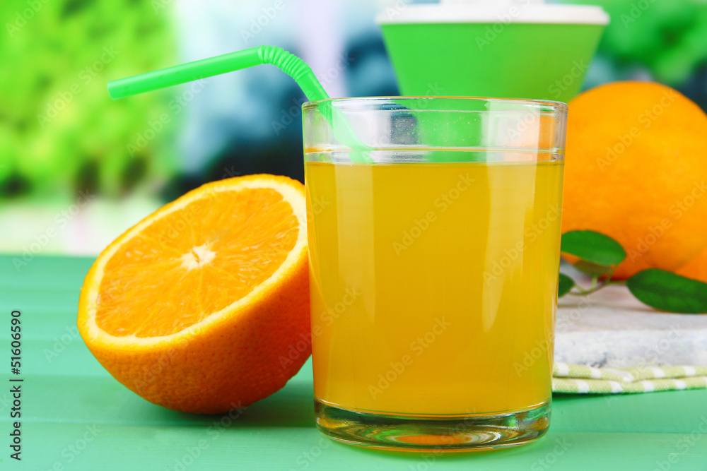 Glass of juice, citrus press and ripe orange Glass of juice, citrus press and ripe orange