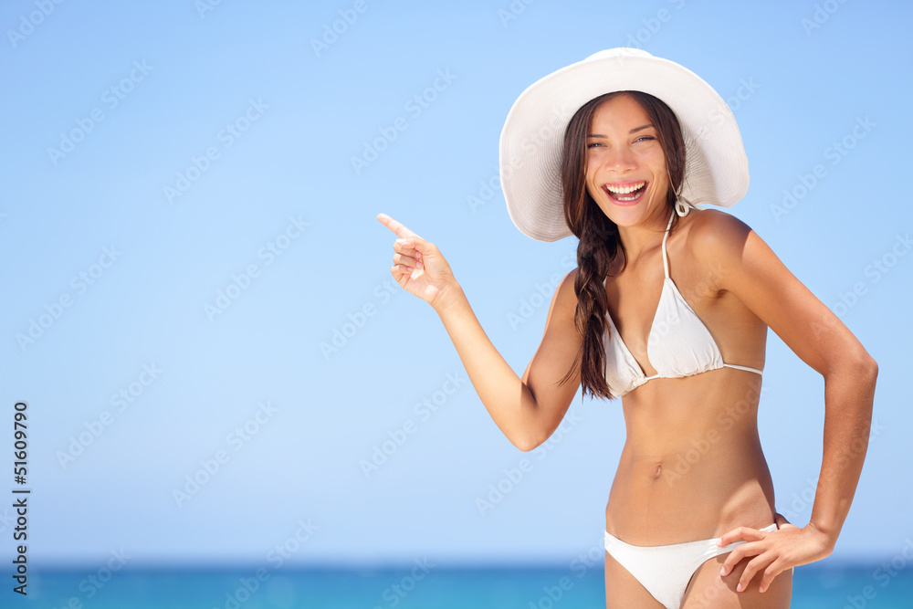 Beach woman pointing showing vacation concept
